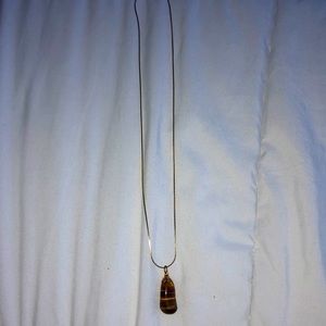 Cold chain necklace with tiger’s eye stone.